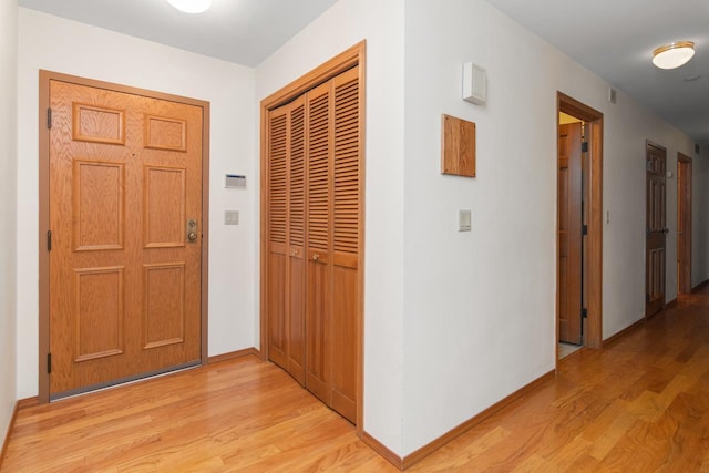 corridor with light wood-type flooring