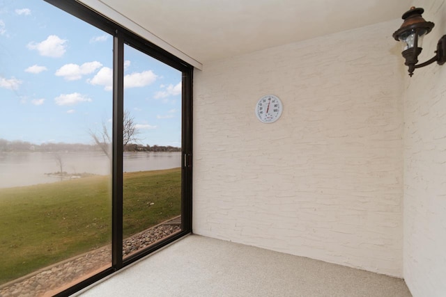 unfurnished sunroom with a water view