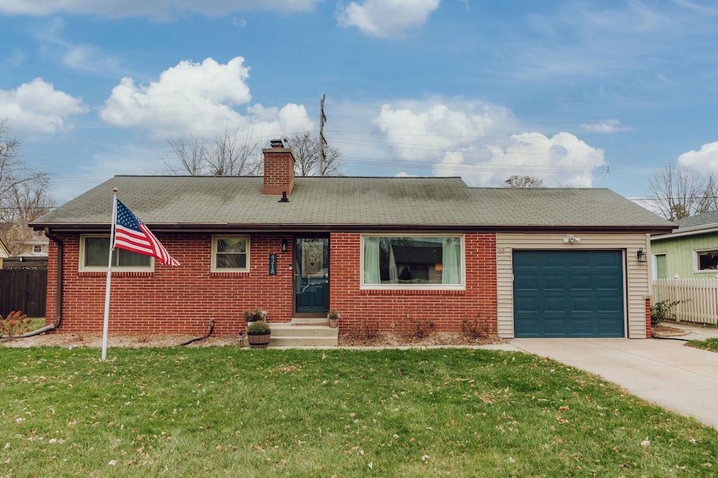 ranch-style house with a front yard and a garage