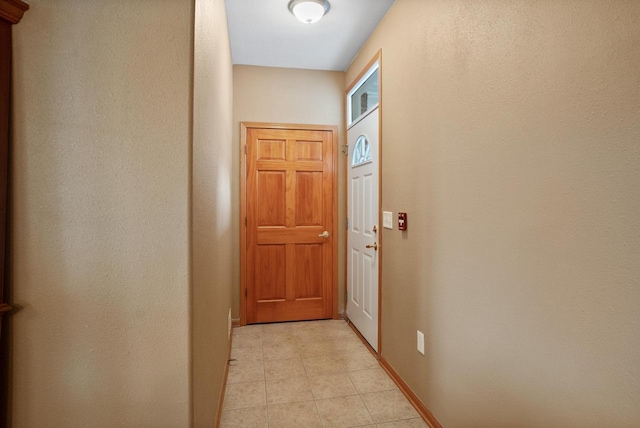 doorway featuring light tile patterned floors