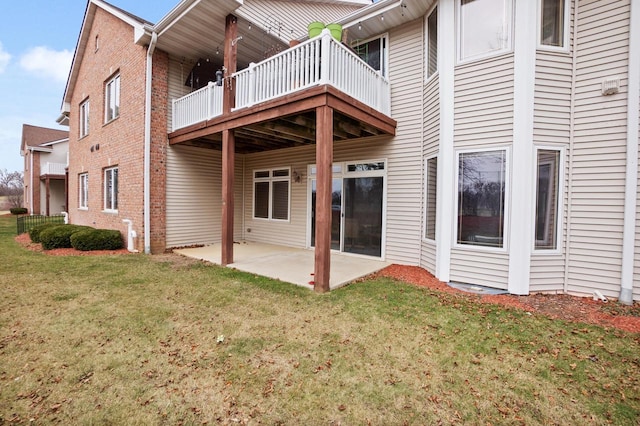 rear view of property with a lawn and a patio area