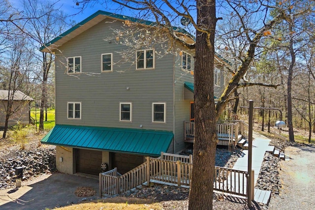 458 Pro Trl, Nekoosa, WI 54457 - rear view of house with a garage, a deck, and asphalt driveway