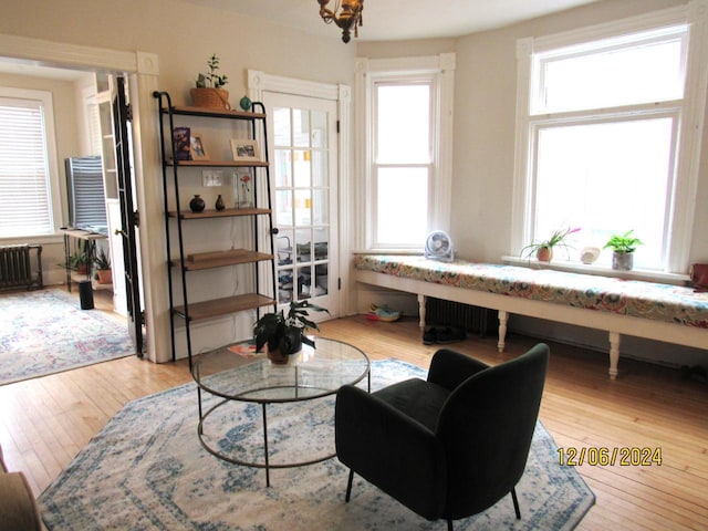 living area with light wood-type flooring and radiator