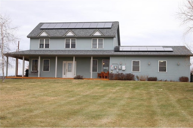 view of front of home featuring covered porch, solar panels, and a front lawn