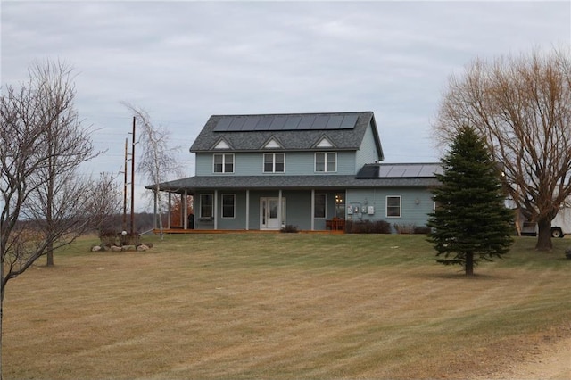 view of front of property with a front yard, a porch, and solar panels