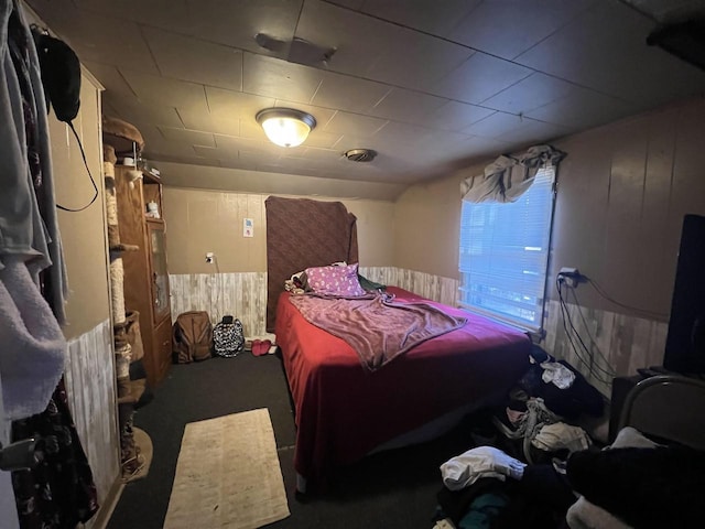 bedroom with wooden walls