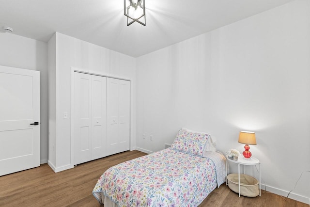 bedroom featuring hardwood / wood-style floors and a closet