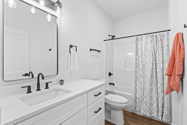 full bathroom featuring hardwood / wood-style flooring, vanity, toilet, and shower / tub combo