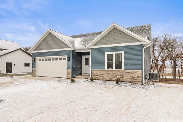 craftsman-style house featuring a garage and central air condition unit