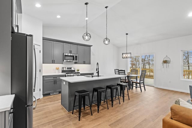 kitchen with a kitchen island with sink, sink, plenty of natural light, and appliances with stainless steel finishes