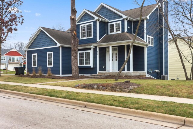 view of front of house with covered porch and a front lawn