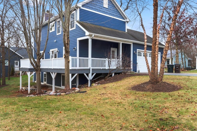 view of front of property featuring a garage and a front lawn