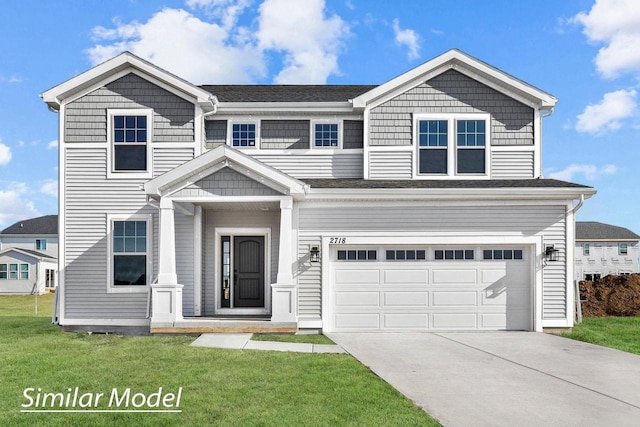 view of front of home featuring a front lawn and a garage