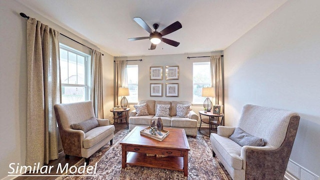 living room featuring ceiling fan and hardwood / wood-style floors