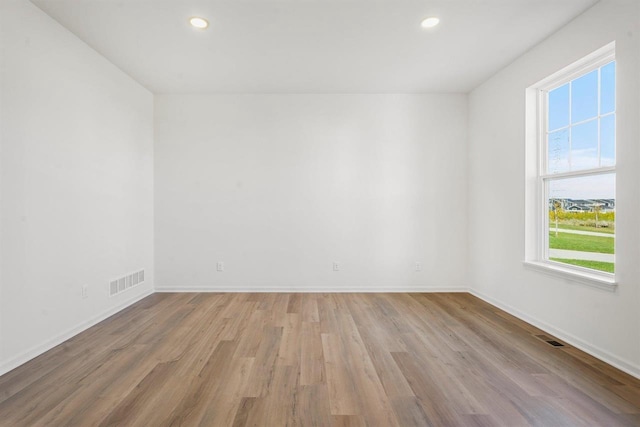 unfurnished room featuring light hardwood / wood-style floors and a wealth of natural light