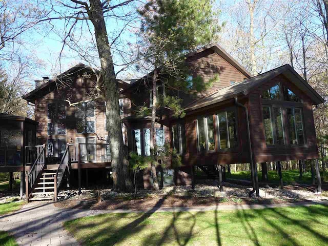 rear view of house with a wooden deck