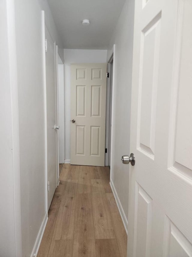 hall with light hardwood / wood-style flooring