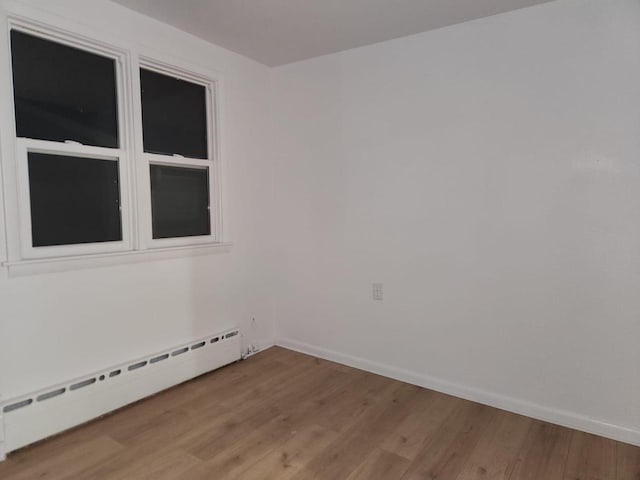 spare room with light hardwood / wood-style flooring and a baseboard radiator