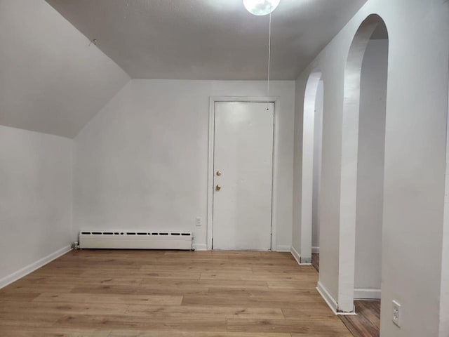 bonus room featuring a baseboard radiator, vaulted ceiling, and light hardwood / wood-style floors