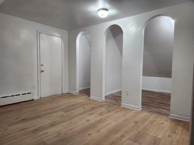 spare room with light hardwood / wood-style floors and baseboard heating