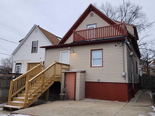 rear view of house featuring a balcony