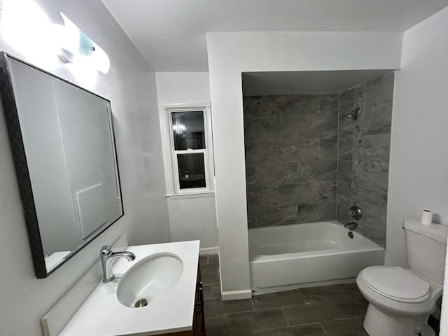 full bathroom featuring vanity, toilet, and tiled shower / bath combo