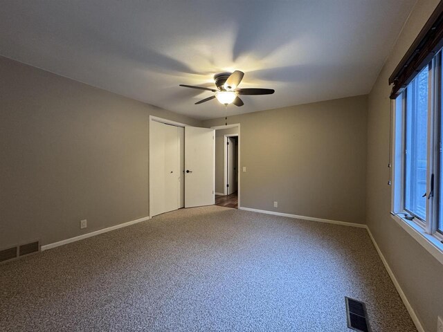 7409 Timberline Trl, Arena, WI 53503 - unfurnished bedroom with carpet, ceiling fan, and a closet