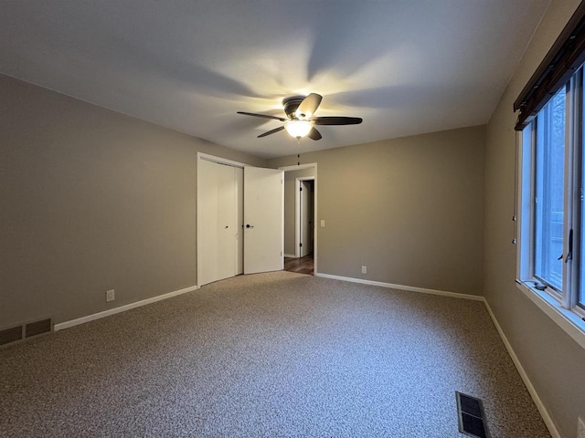 carpeted empty room with ceiling fan