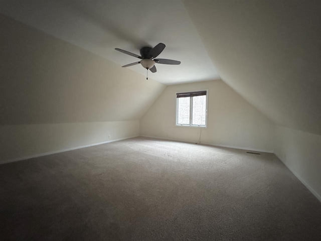 additional living space with ceiling fan, carpet floors, and lofted ceiling