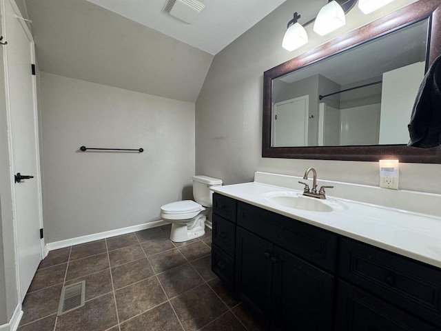 bathroom featuring toilet, tile patterned floors, vanity, and vaulted ceiling