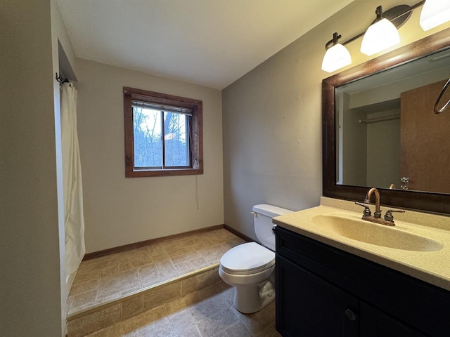 bathroom with vanity, toilet, and curtained shower