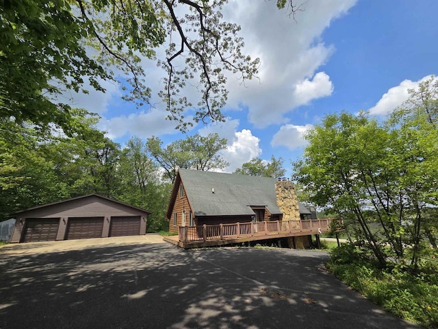 7409 Timberline Trl, Arena, WI 53503 - view of front of home featuring a detached garage, a wooden deck, an outdoor structure, and a chimney