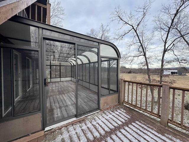 wooden deck with a sunroom