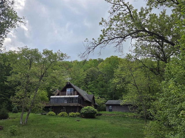 7409 Timberline Trl, Arena, WI 53503 - rear view of property featuring a view of trees, a lawn, and a deck
