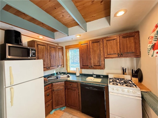 kitchen with beam ceiling, white appliances, sink, and light hardwood / wood-style flooring