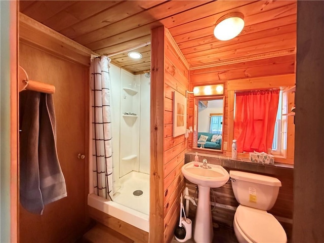 bathroom with a shower with shower curtain, wooden ceiling, toilet, and wooden walls