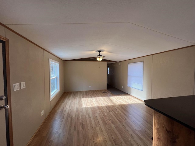 unfurnished living room featuring ceiling fan, light hardwood / wood-style flooring, and lofted ceiling