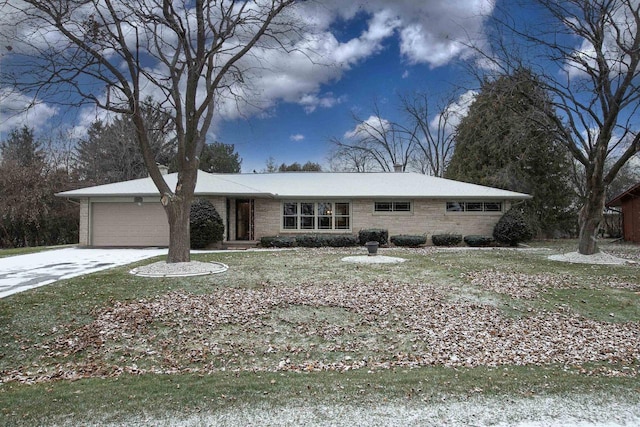 ranch-style home featuring a front lawn and a garage