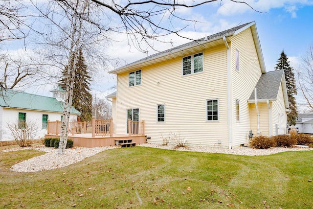 rear view of property with a lawn and a deck