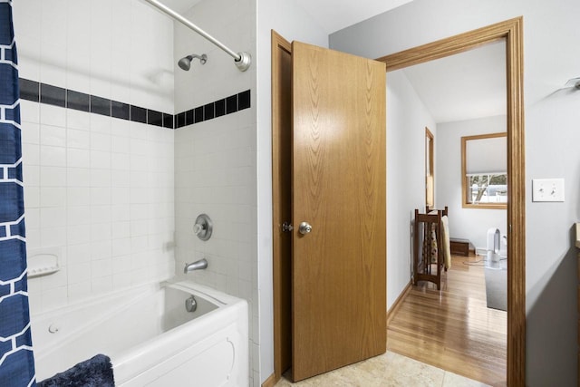 bathroom with hardwood / wood-style floors and shower / bath combo