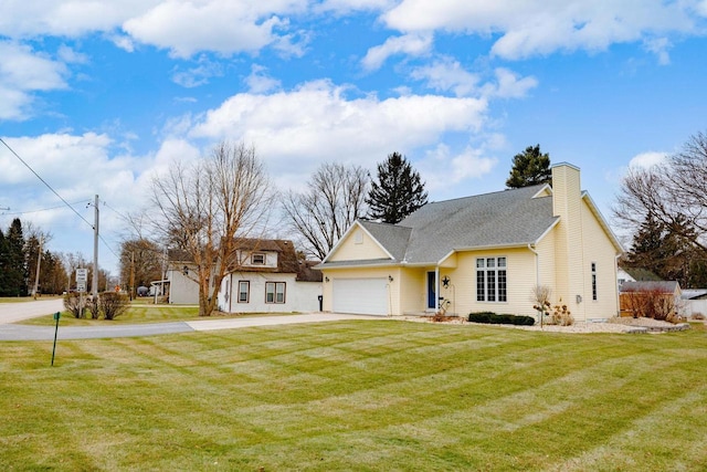 view of front of property with a garage and a front lawn