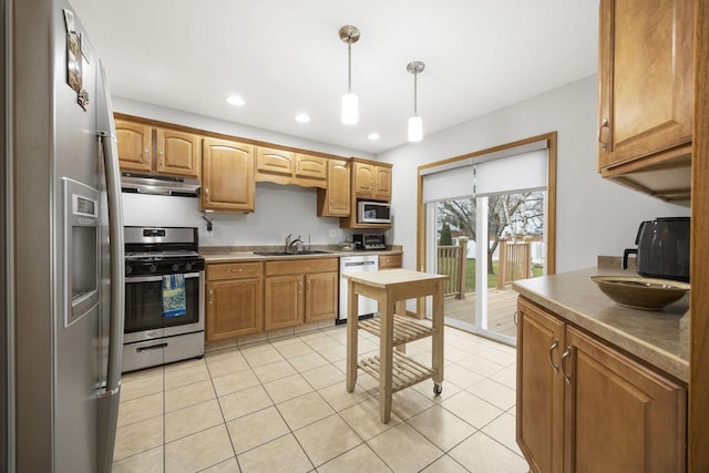 kitchen with pendant lighting, sink, light tile patterned floors, and stainless steel appliances