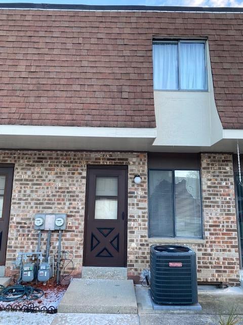 entrance to property featuring central AC unit