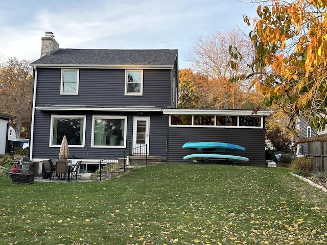 rear view of property with a yard and a patio