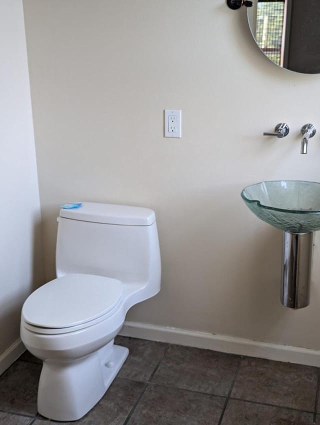 bathroom with tile patterned floors and toilet