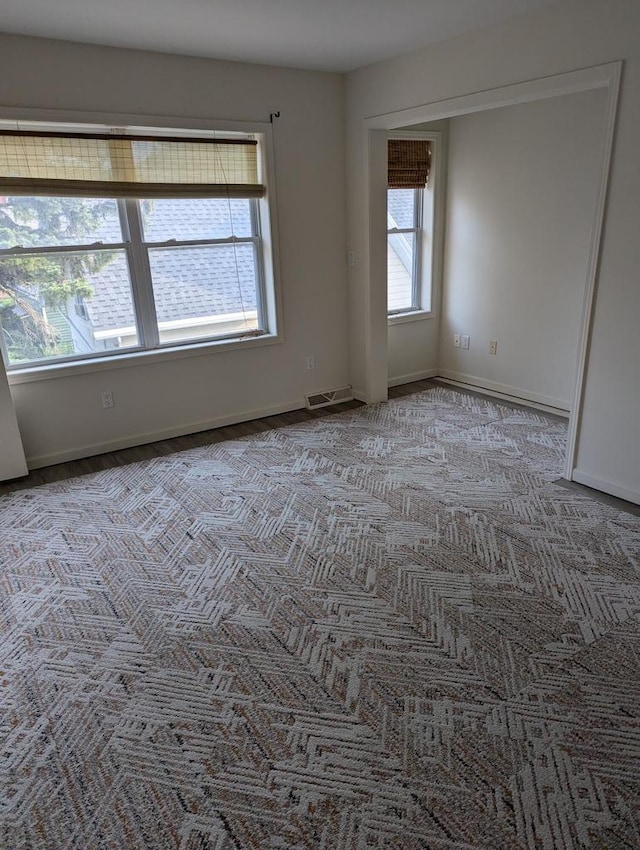 spare room featuring light colored carpet