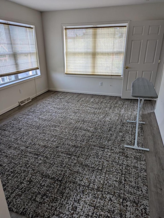 empty room with dark wood-type flooring