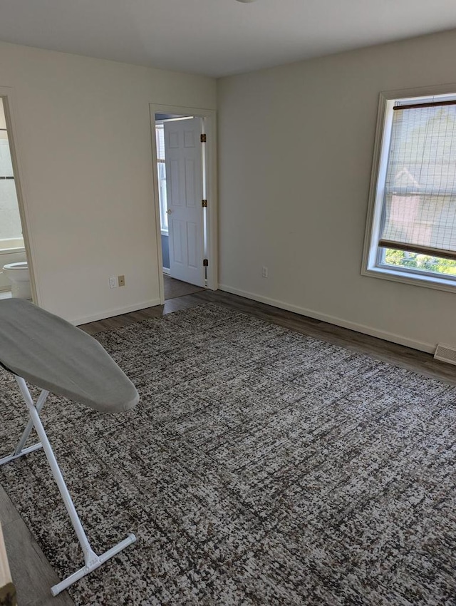 empty room featuring dark hardwood / wood-style flooring