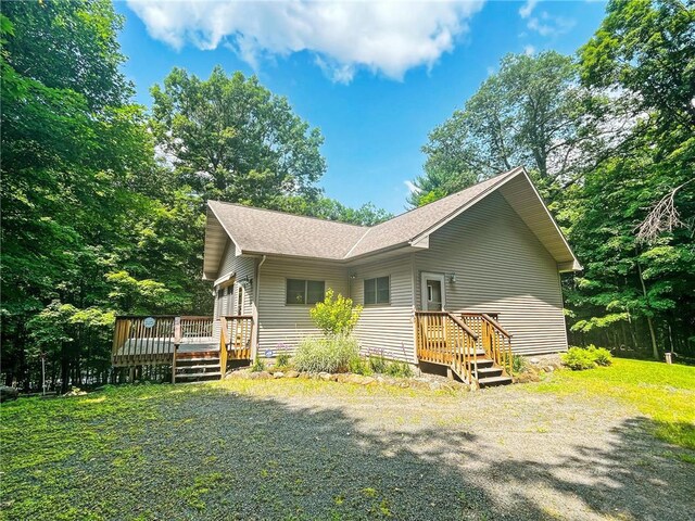 back of house with a wooden deck