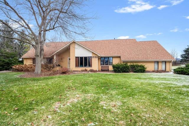 ranch-style home featuring a front yard